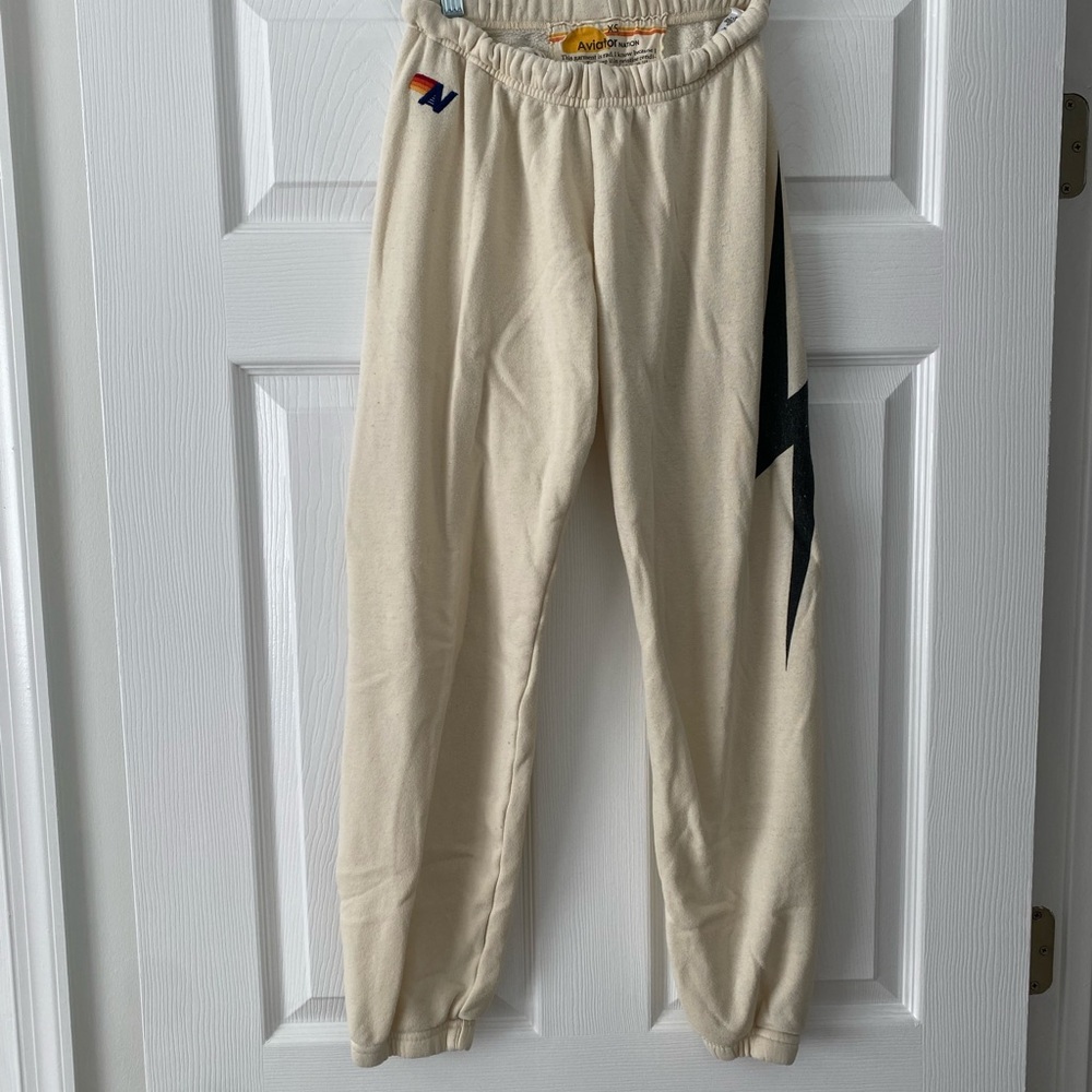 Aviator Nation Cream Track Pants with Black Lightning Bolt